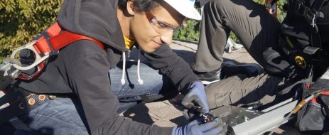 Smiling trainee working on the roof